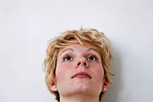 Young blond girl with morning look and mixed hairs on a white background