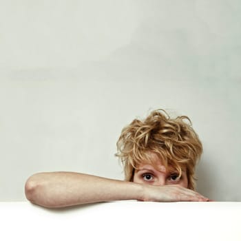 Young blond girl with morning look and mixed hairs on a white background