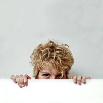 Young blond girl with morning look and mixed hairs on a white background