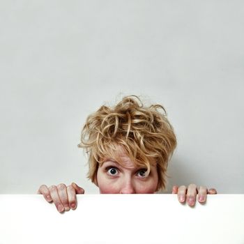 Young blond girl with morning look and mixed hairs on a white background