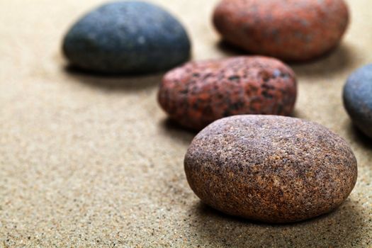 Pebble stones background with copy space. Sand beach texture. Macro shot
