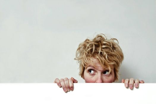 Young blond girl with morning look and mixed hairs on a white background