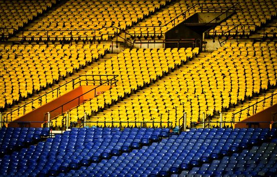 Abandoned and Empty Stadium with yellow and blue seats (nobody)