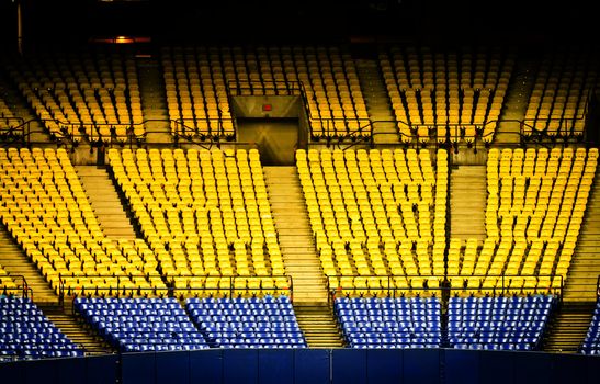 Abandoned and Empty Stadium with yellow and blue seats (nobody)