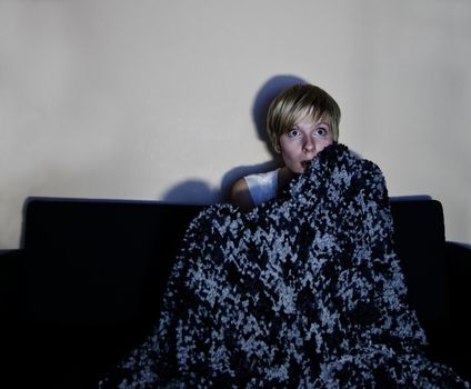 Series of images of a young person / couple sitting on a couch wrapped and listening to the television