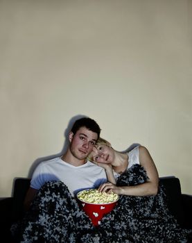 Series of images of a young person / couple sitting on a couch wrapped and listening to the television