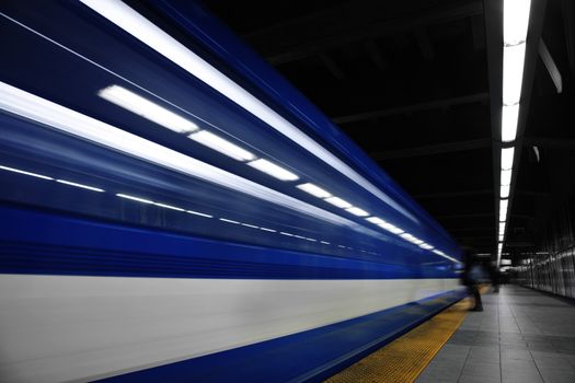 A Girl Waiting the metro to stop. A long exposure with a lot of movement.