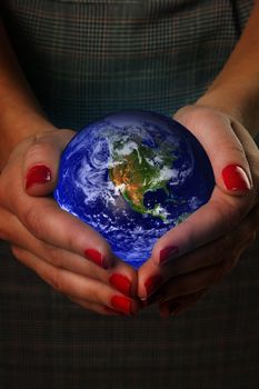 Women's hands holding the earth. Elements of this image furnished by NASA