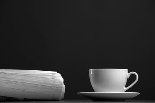 White mug and newspaper on a gray background