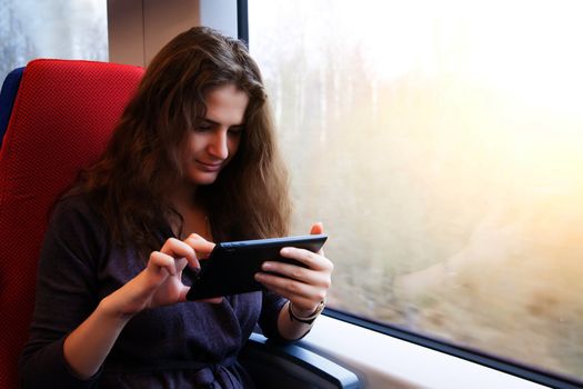 A woman with a tablet pc on a train ride