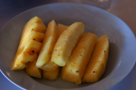 close up fresh pineapple pieces on dish