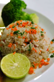 close up fried rice with mix vegetable , served with slice lime