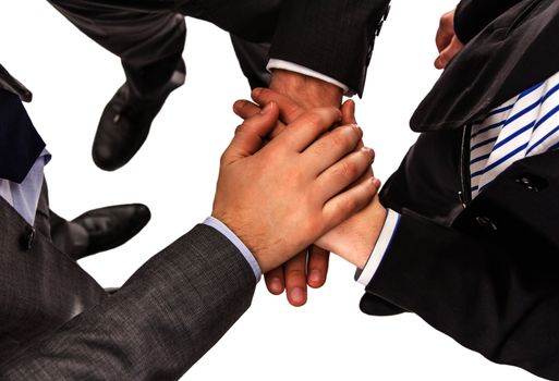 Closeup of business partners with hands on top of each other showing power and unity in a teamwork
