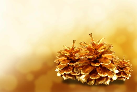 Golden pine cone isolated on white
