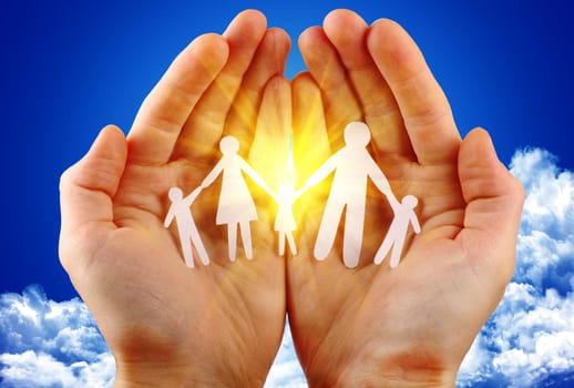 paper family in hand sun and blue sky with copyspace showing freedom or solar power concept