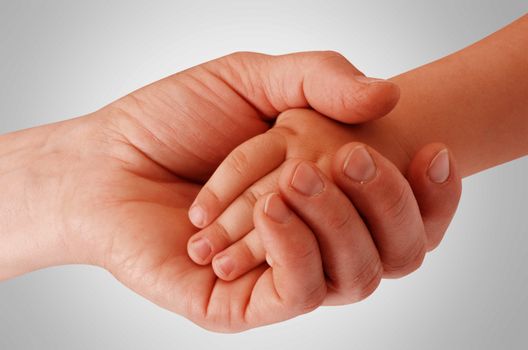 Mother holding child's hand