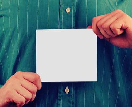 Closeup of businessman's hand holding up card