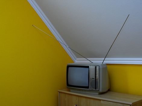 Old, vintage tv set in the corner of the room 