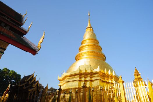 Golden pagoda in Wat Phra That Mon Haripunchai in Lamphun, Thailand.