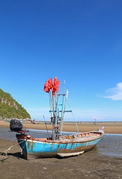 Fishing boat on the beach in front of the Pranburi sea in Thailand