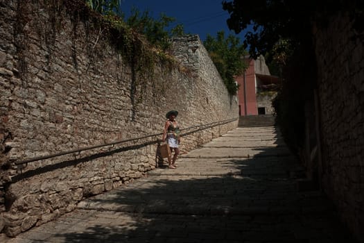 A tourist on the streets of the historic center of Pula, Croatia