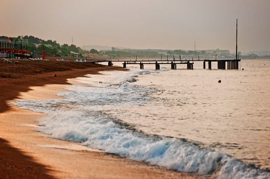 Sandy beach on the Mediterranean Sea at dawn.