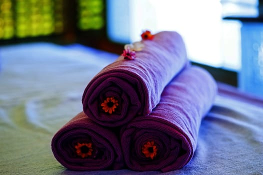 Towels on the bed in a spa decorative decorated.