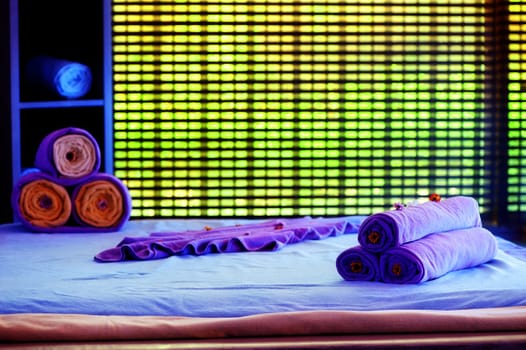 Towels on the bed in a spa decorative decorated.