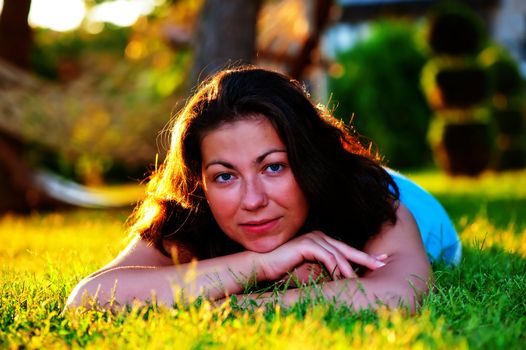 Brunette girl lying on the grass