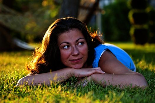 Brunette girl lying on the grass