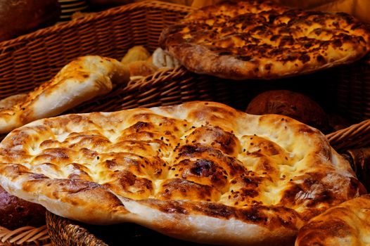 Bread cake lying on a basket with bread