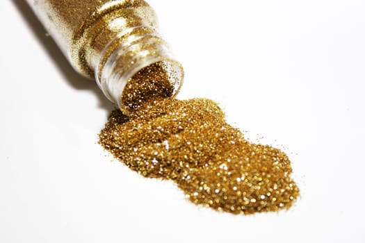 Gold glitter powder coming out from a bottle