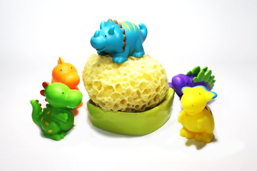 funny colored plastic dinosaurs for bathing babies with sponge