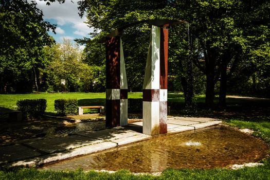 Fountain in a city park of a Bavarian town on a day with sun in spring