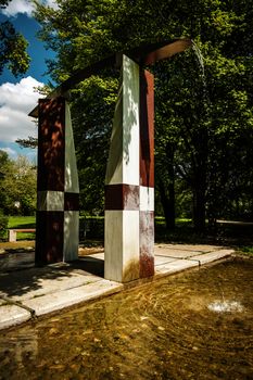 Vertical picture of fountain in a city park in spring on a day with sun