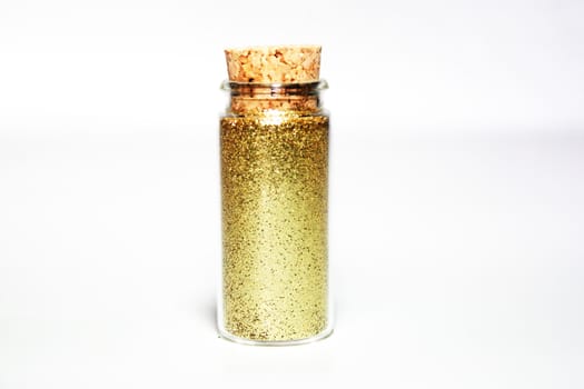 Gold glitter powder in a glass small bottle