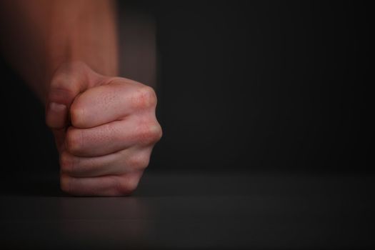 Man fist hit with a sweep of the table.