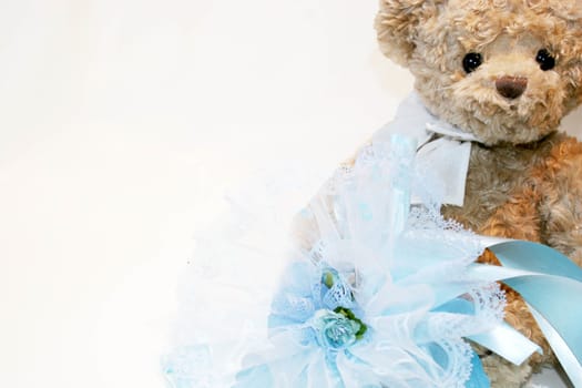 Cute teddy bear with a blue ribbon celebration of a male baby newborn