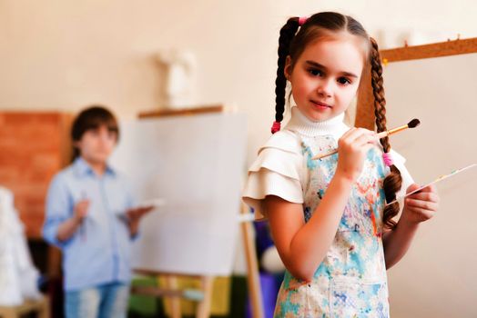 portrait of a girl standing next to his easel, a drawing lesson