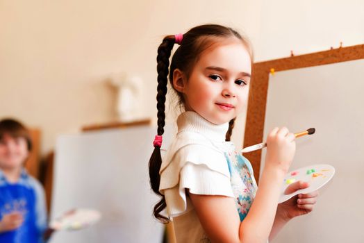 portrait of a girl standing next to his easel, a drawing lesson