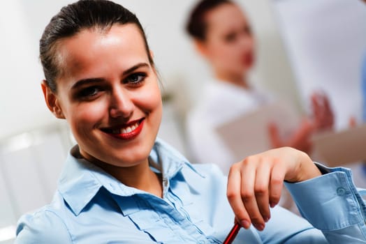 portrait of a business woman in office, smiling and looking into the camera, office work
