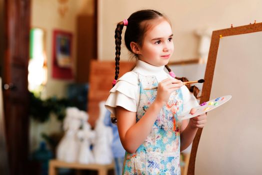 portrait of a girl standing next to his easel, a drawing lesson