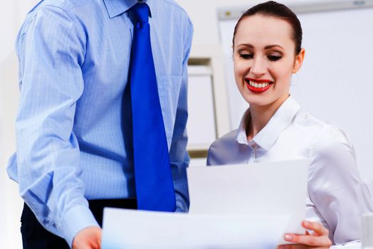 colleagues discuss the reports at a desk in the office, working together in business