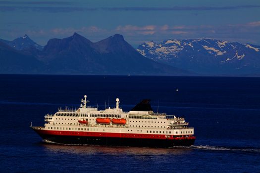 Passenger ship cruising along norwegian coast near Lofoten islands