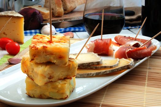 Platter consisting of potato omelette, cheese and serrano ham