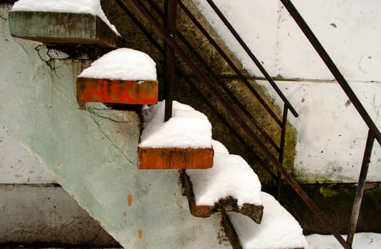 powdery snow cover the old cement stairs.
