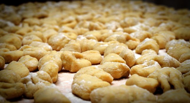 Lots of freshly prepared handmade italian gnocchi, traditional pasta