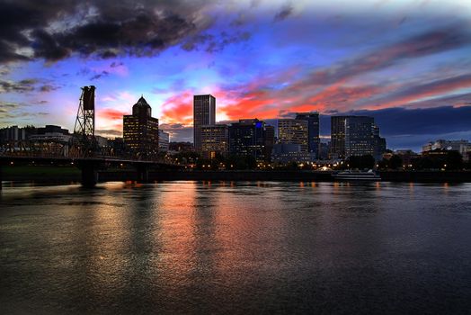 Portland Oregon Downtown City Skyline with Historic Hawthorne Bridge Across Willamette River at Sunset