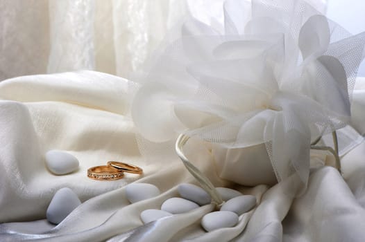 wedding favors and wedding ring on white background