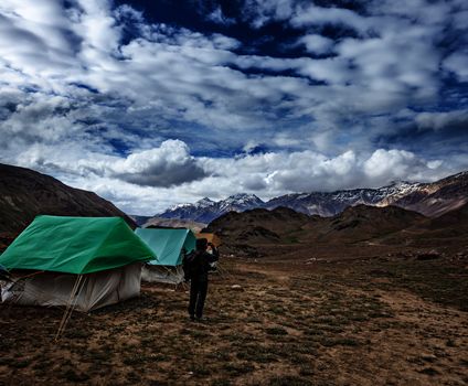 Photographer taking photos in Himalayas mountains with mobile phone. Spiti valley, Himachal Pradesh, India